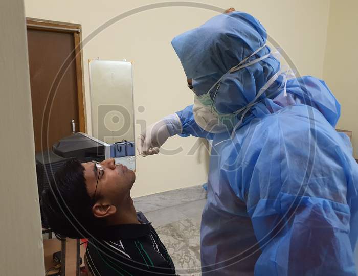 July 03 2020, A Physician Wearing Full Personal Protective Gear Taking Nasal Swab Of A Patient For Covid 19 Testing