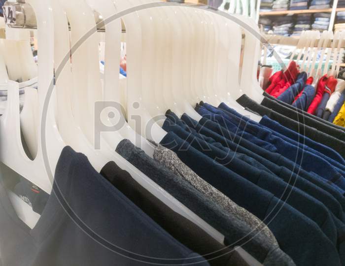 Shirts Are Displayed In An Array Using Hangers Inside A Textile Showroom.