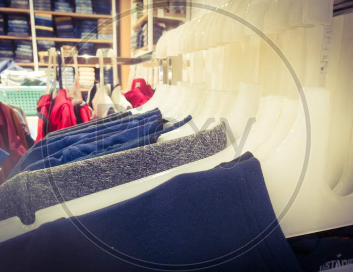 T Shirts In Hangers Are Aligned In An Array Inside A Textile Showroom.