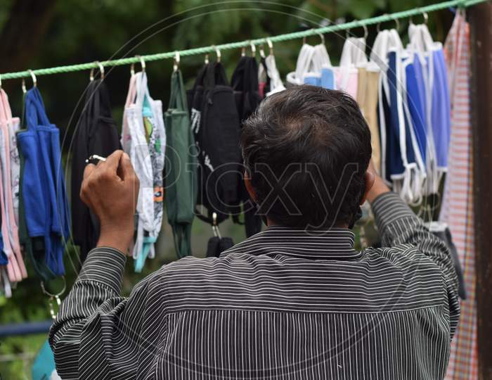 Hyderabad, Telangana, India. july-22-2020: masks at road side, man selling face masks at road side while wearing face mask for protection from the coronavirus, corona pandemic time, selective focus