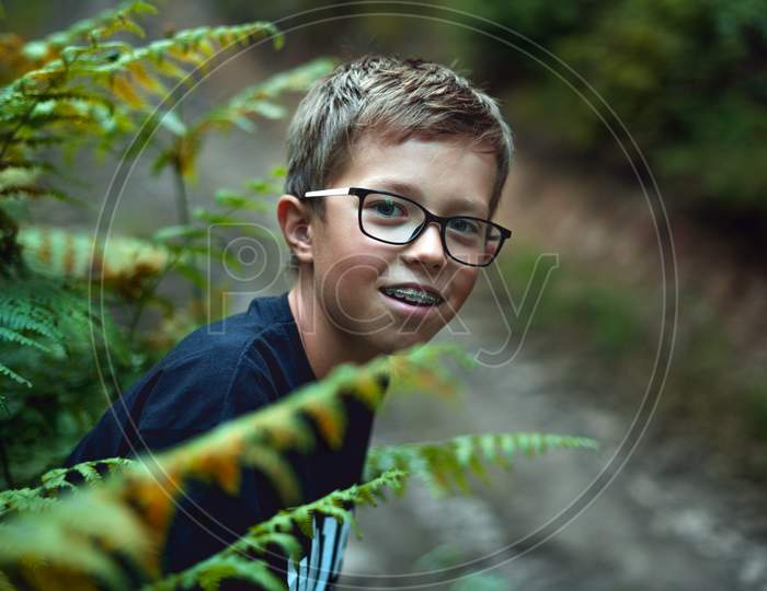 Portrait of Young teenager boy In the forest