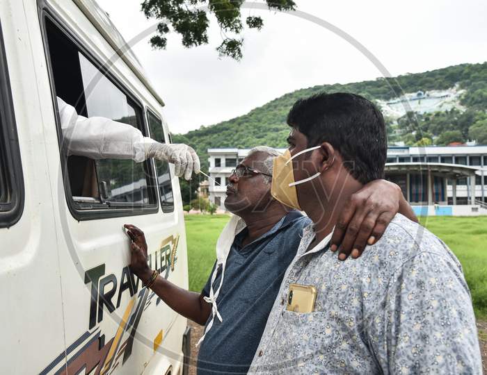 A Medic Collects A Swab Sample Of An Old Man For The Covid-19 Test From A Swab Collection Van In Vijayawada.