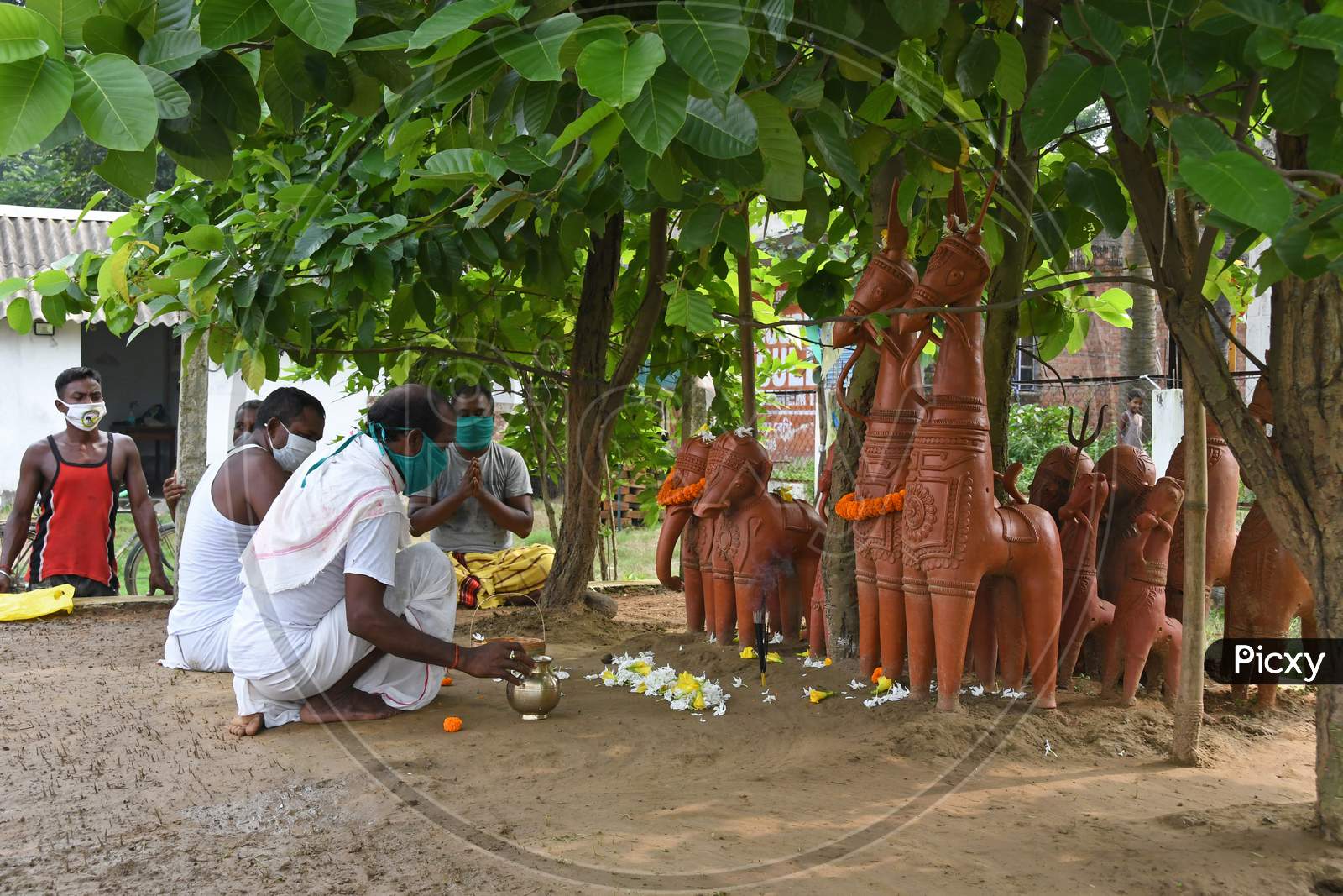People of the Santal community prayed through religious ceremonies to save people all over the world from the COVID-19