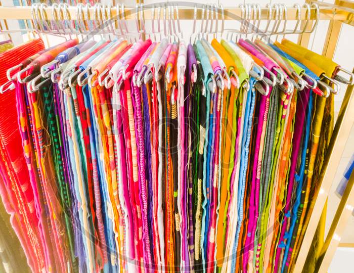 Image of A Set Of Sarees Hanging On Hangers In A Textile Showroom ...