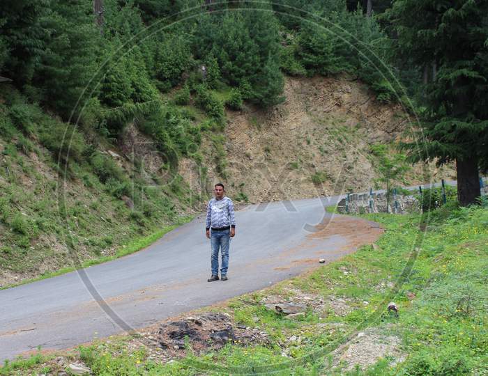 tourist taking a walk down the road in Bhaderwah
