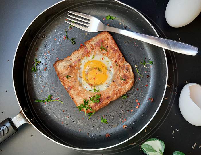 Egg in a hole | Herbs | Chili Flakes