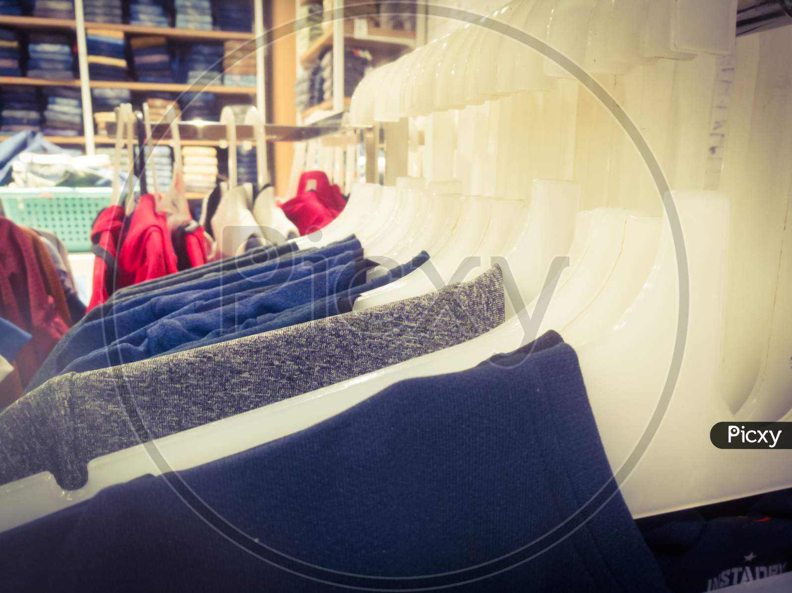 T Shirts In Hangers Are Aligned In An Array Inside A Textile Showroom.