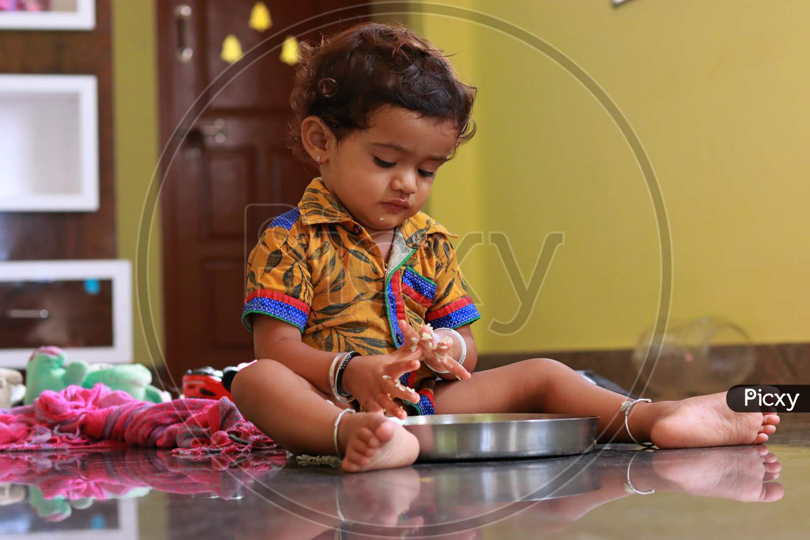 A Child Looking At Food In A Plate