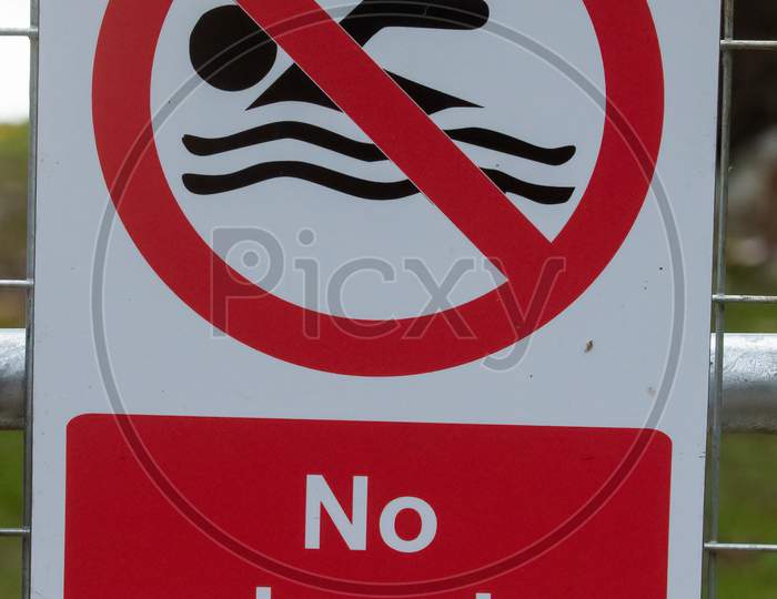 No Swimming Sign On Gate Close Up