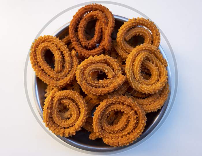 Top Shot Of Traditional Chakali Snacks Isolated On White Background