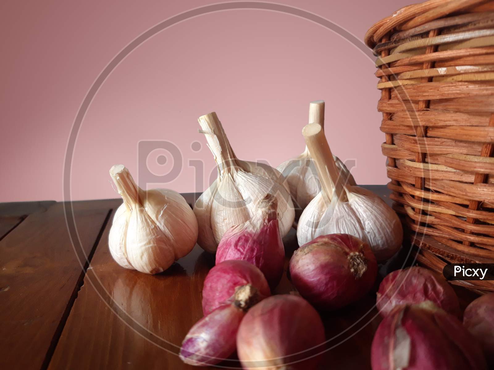 Shallots And Garlic Beside The Wicker Basket