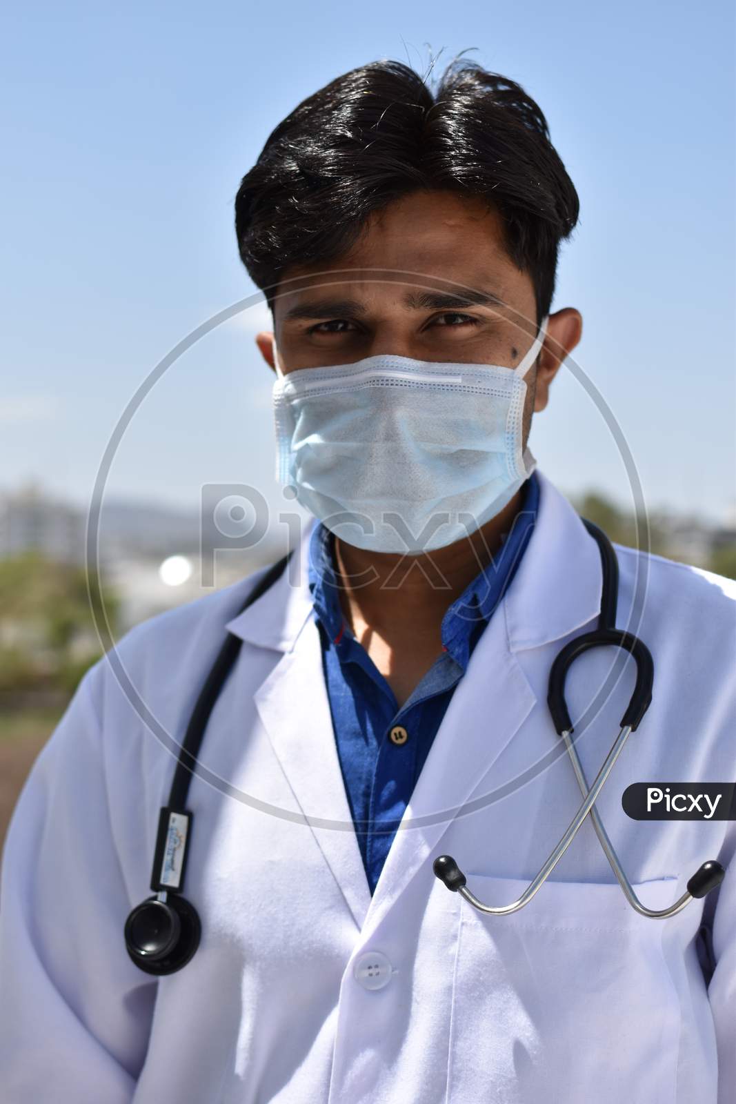 male indian doctor in white coat with Stethoscope and mask