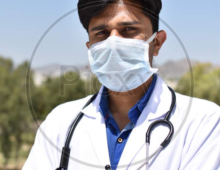 Indian doctor with mask white coat and stethoscope