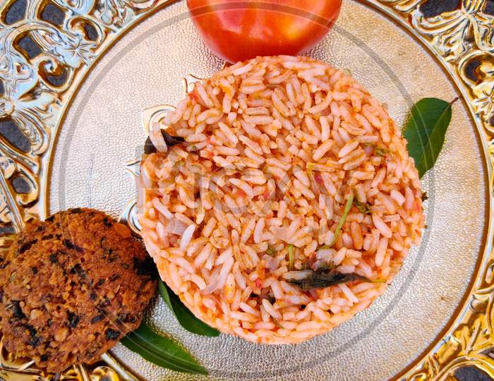 Tasty Tomato Rice With Vada Kept In Gold Plate. A South Indian Recipe.