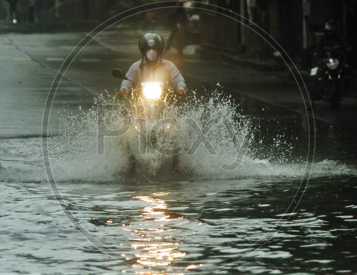 A bike rides through a waterlogged road during rains, in Mumbai, India, July , 2020.