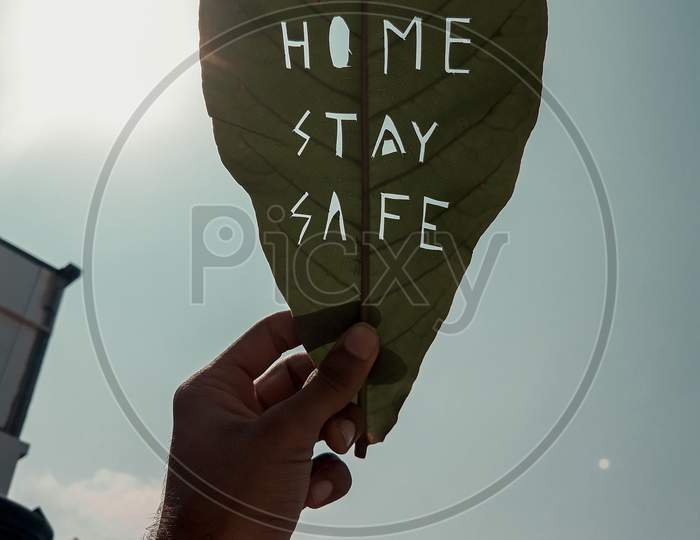 Stay safe stay home quote on leaf
