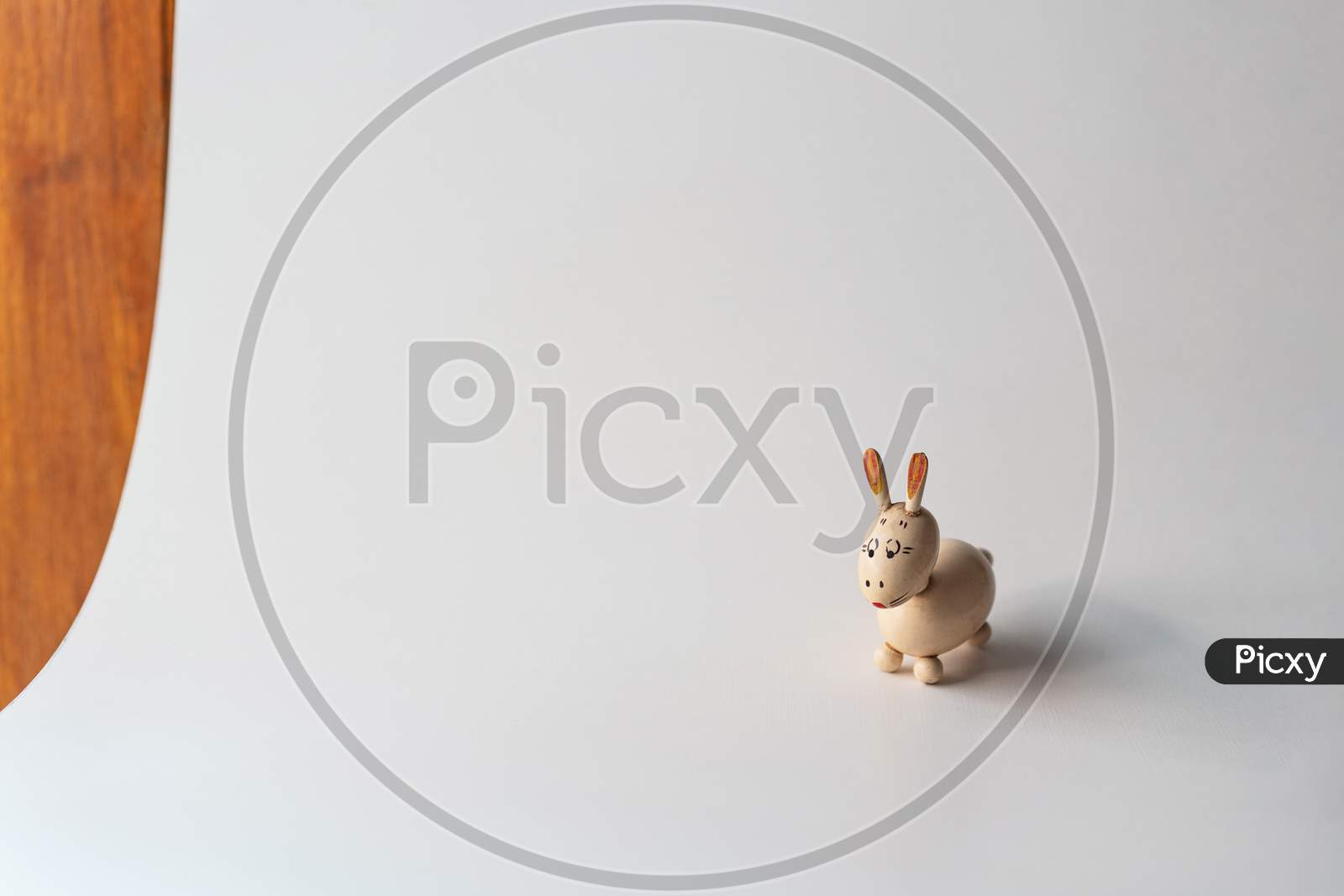Small wooden bunny figurine isolated on white