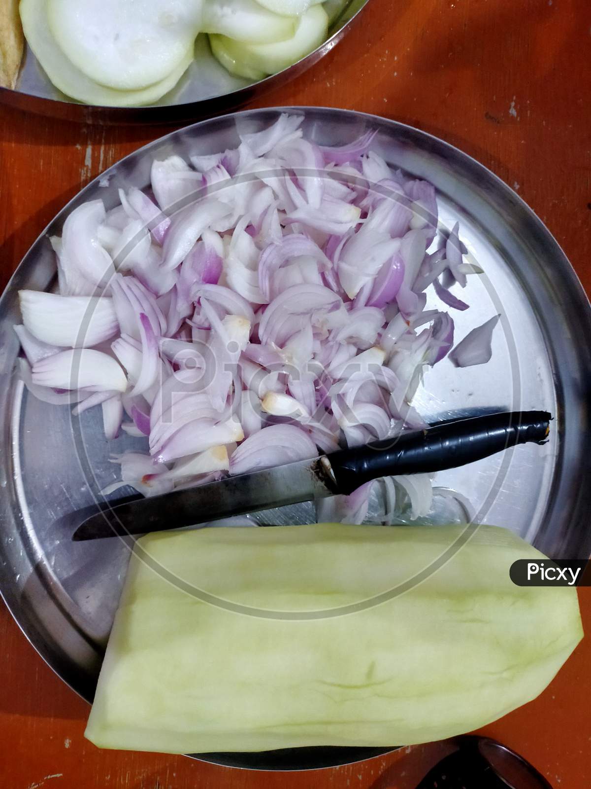 Cutting vegetable to cook food.
