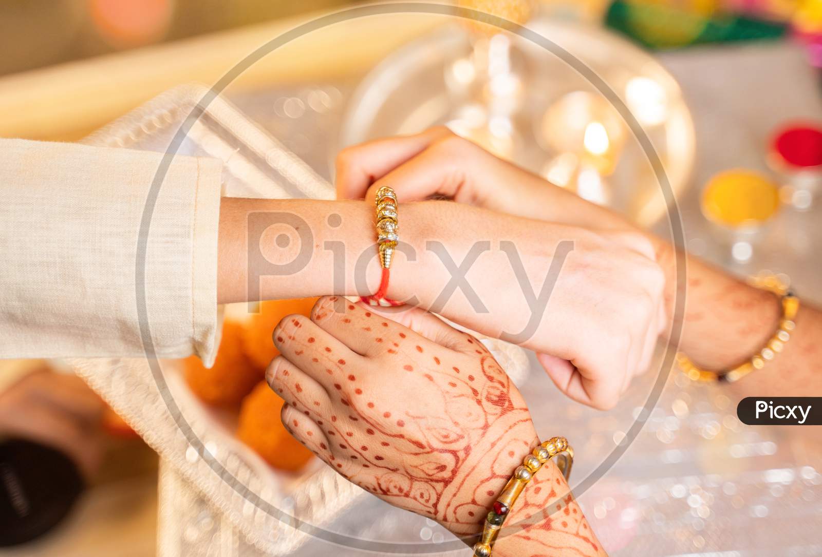 Closeup Of Hands, Sister Tying Rakhi, Raksha Bandhan To Brother'S Wrist During Festival Or Ceremony - Rakshabandhan Celebrated Across India As Selfless Love Or Relationship Between Brother And Sister