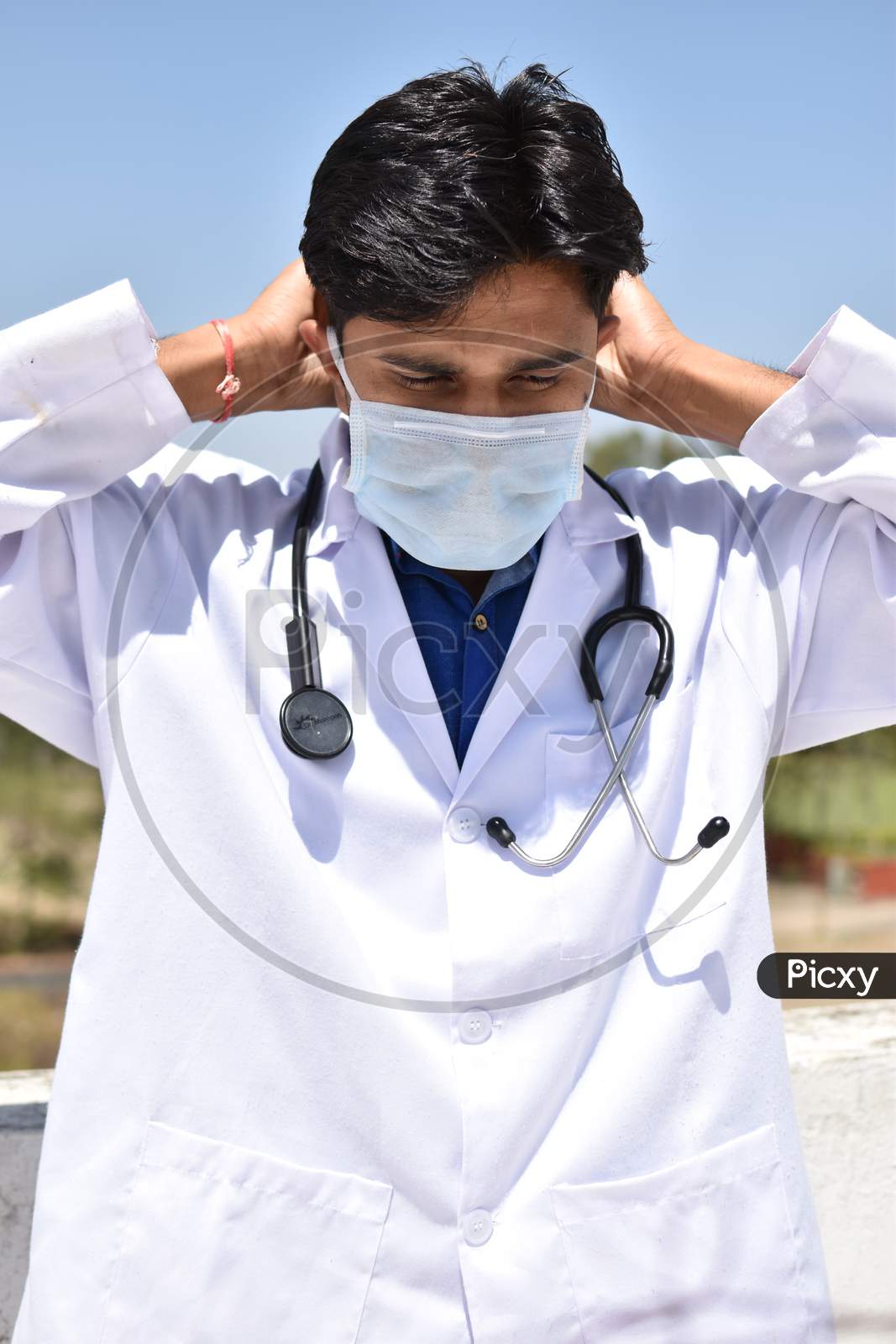 male indian doctor in white coat with Stethoscope and mask