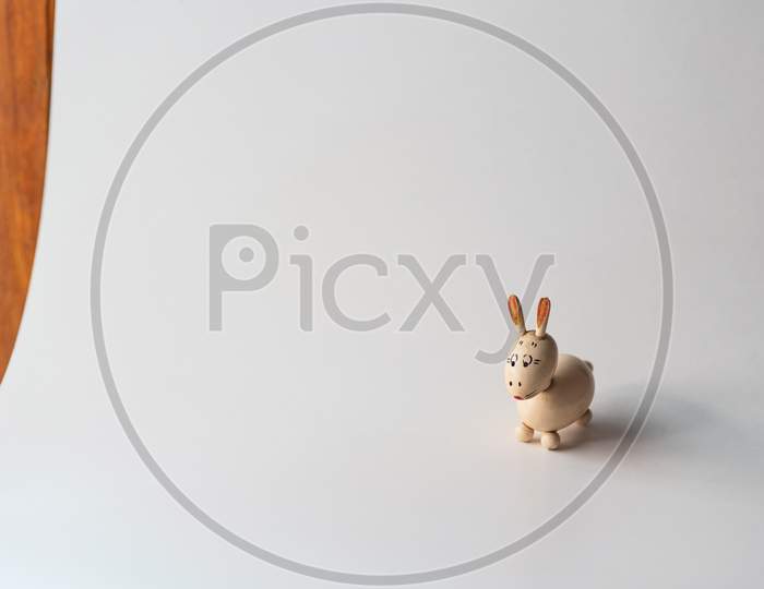 Small wooden bunny figurine isolated on white