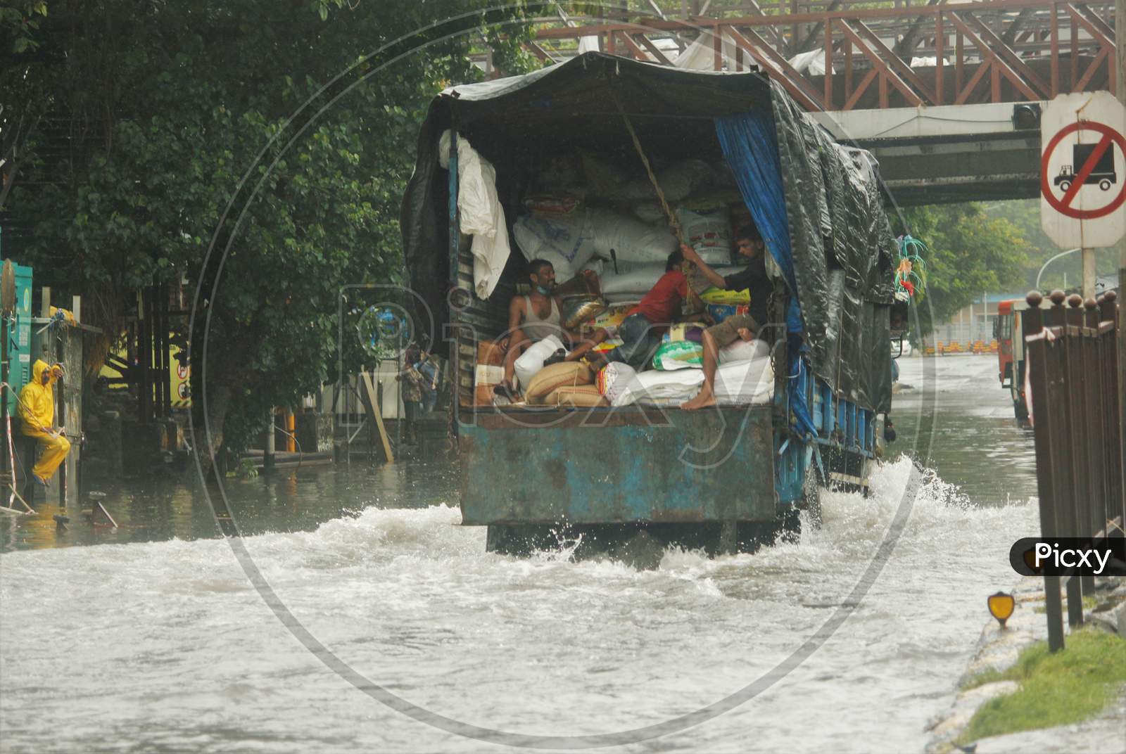 A truck drives through a waterlogged street during heavy rains, in Mumbai, July, 2020.