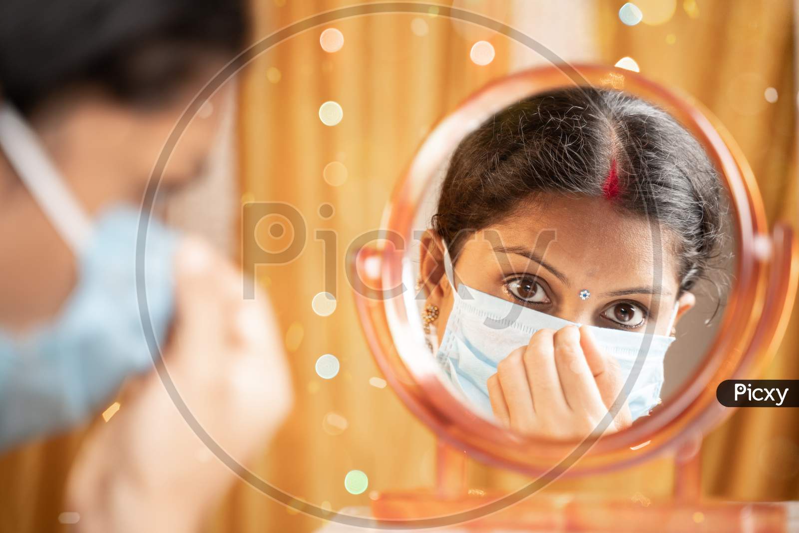 Indian Woman Getting Ready In front Of Mirror By Adjusting Medical Mask Before Going Out During Festival Celebration - Concept Of New Normal Due To Coronavirus Or Covid-19 Pandemic