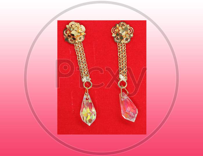 A Pair Of Gold Earrings In Demand