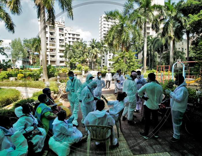 Group of healthcare workers assemble inside a garden before starting a check-up campaign for the coronavirus disease (COVID-19), in Mumbai, India on July 26, 2020.