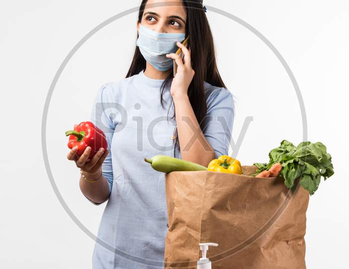 Pretty Indian Girl Or Woman Holding Bag With Vegetables And Fruits