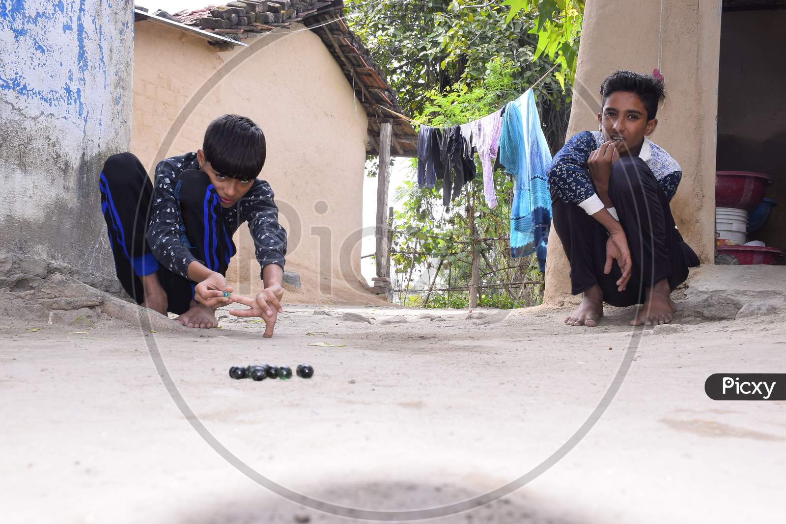 Indian Children Playing Marbles In The Village, Beautiful View Of Rural Sports