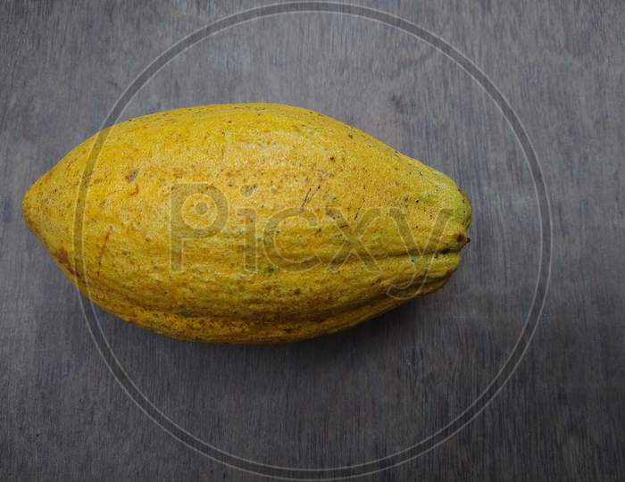 Ripened cocoa fruits on a wooden background
