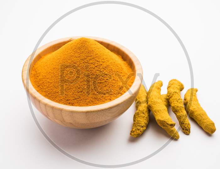 Organic Haldi Or Turmeric Powder Spice Pile In A Bowl With Whole, Selective Focus