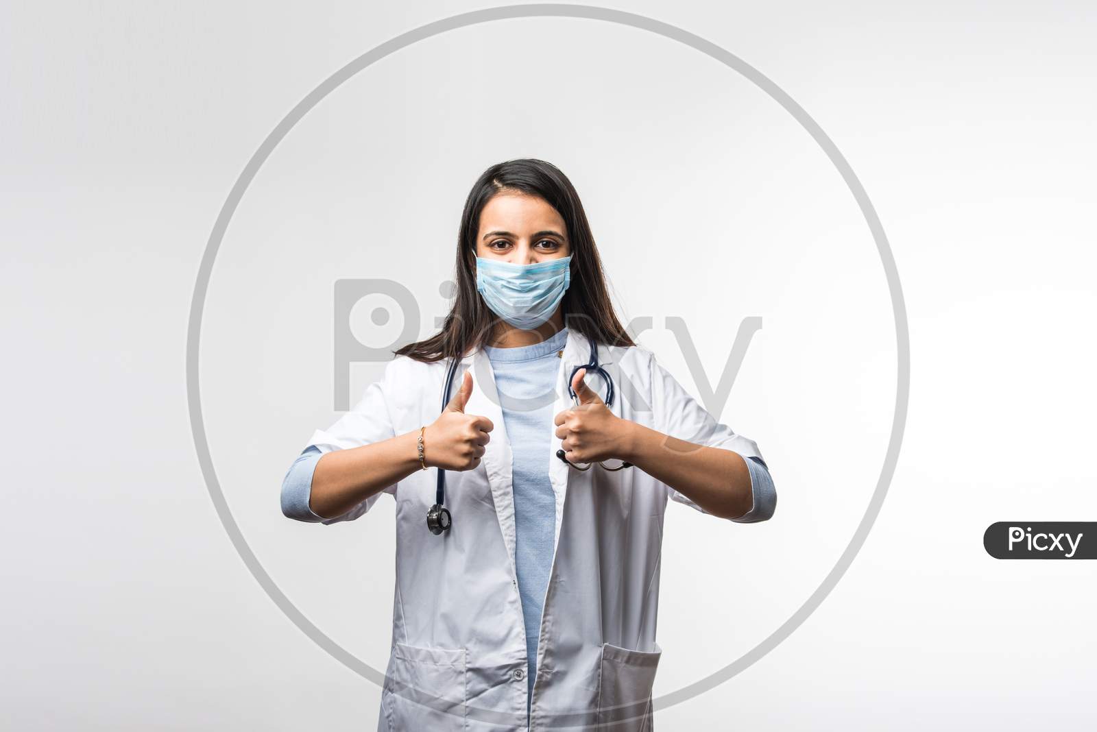 Pretty Indian Female Doctor In Uniform Wearing Medical Face Mask