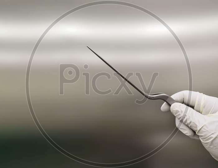 Surgeon Holding Bayonet Forceps