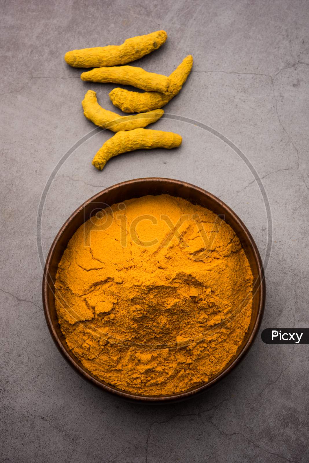 Organic Haldi Or Turmeric Powder Spice Pile In A Bowl With Whole, Selective Focus