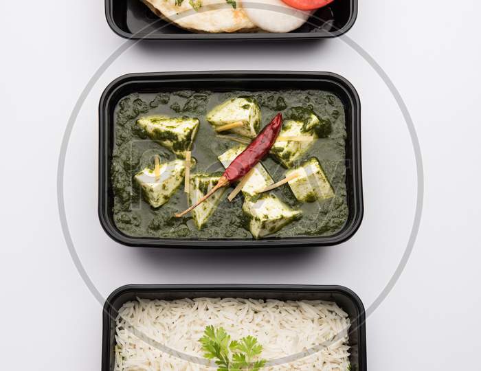 Online Food Delivery Concept Showing Palak Paneer In A Plastic Container With Lid, Indian Food