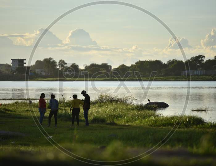 People spend their evenings with families at Ameenpur Lake in Hyderabad amid rising concerns of Coronavirus on July 26, 2020.