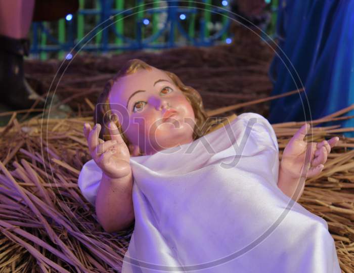 A model of the Nativity scene at Jesus birth in a stable in Bethlehem. Dummy human model statue with selective focus.