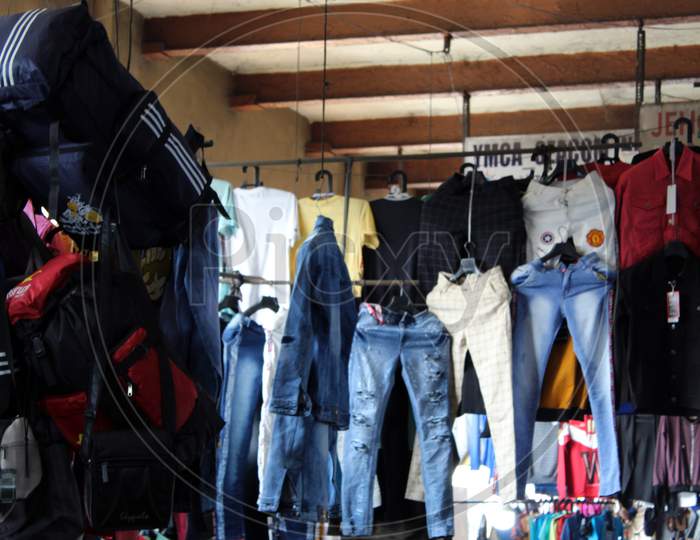 Variety of jeans pant and cloths selling on a open shop at a busy market, at Esplanade, Kolkata.