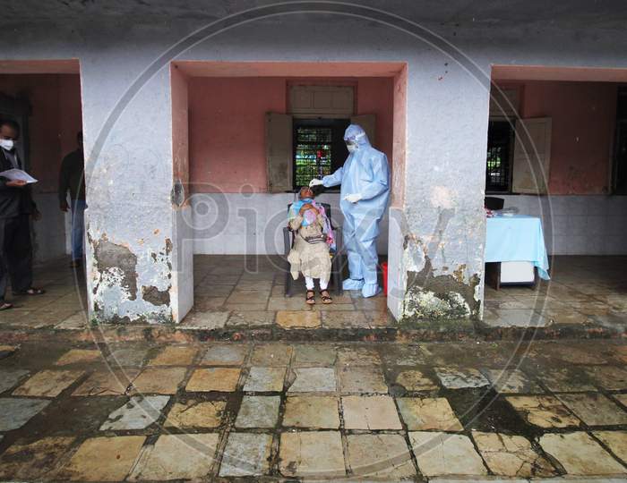 A healthcare worker wearing personal protective equipment (PPE) collects a swab sample from a person during a check-up campaign for the coronavirus disease (COVID-19), in Mumbai, India on July 28, 2020.