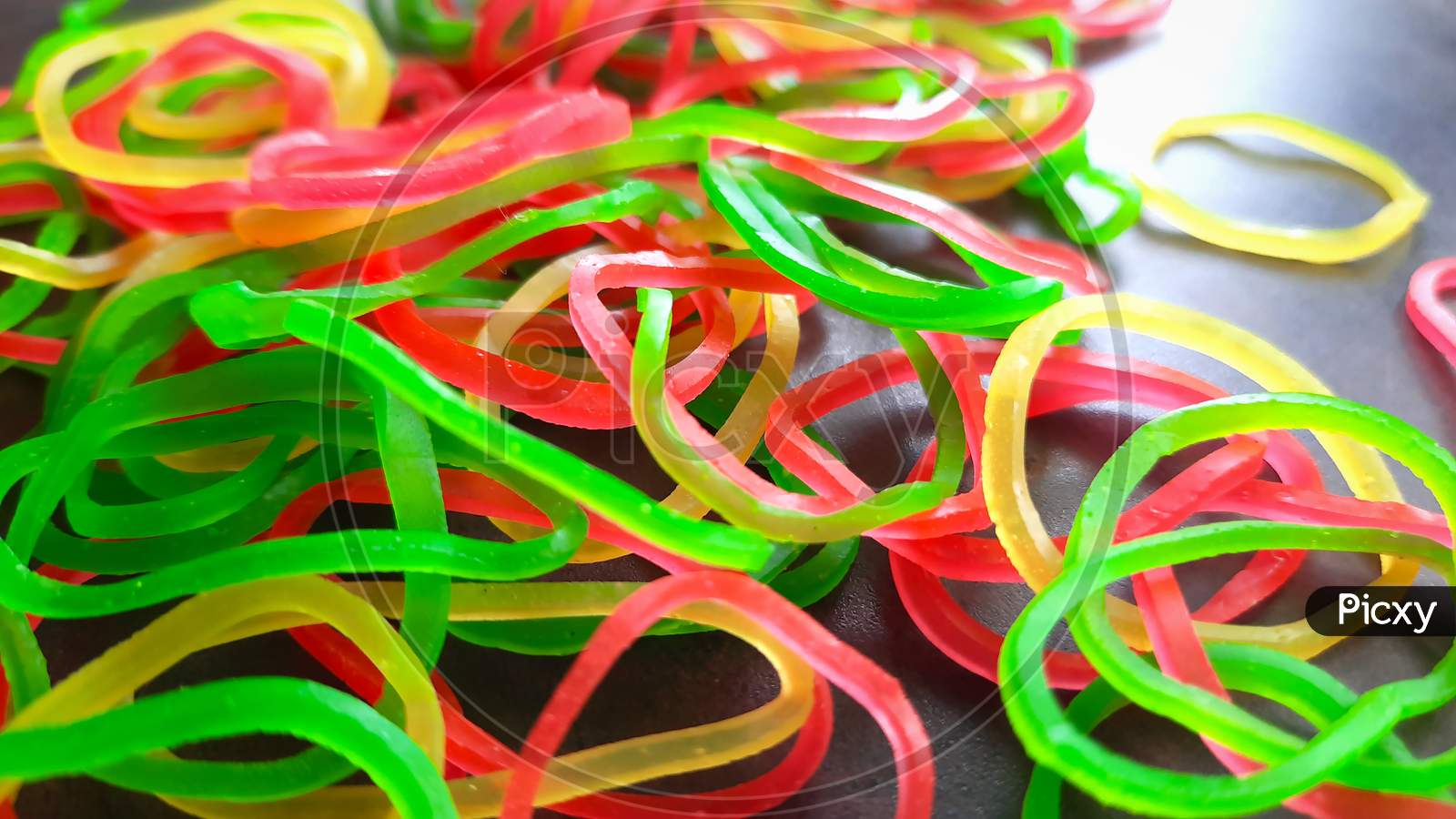 Closeup Of Rubber Bands On Workspace In Office Selective Focus