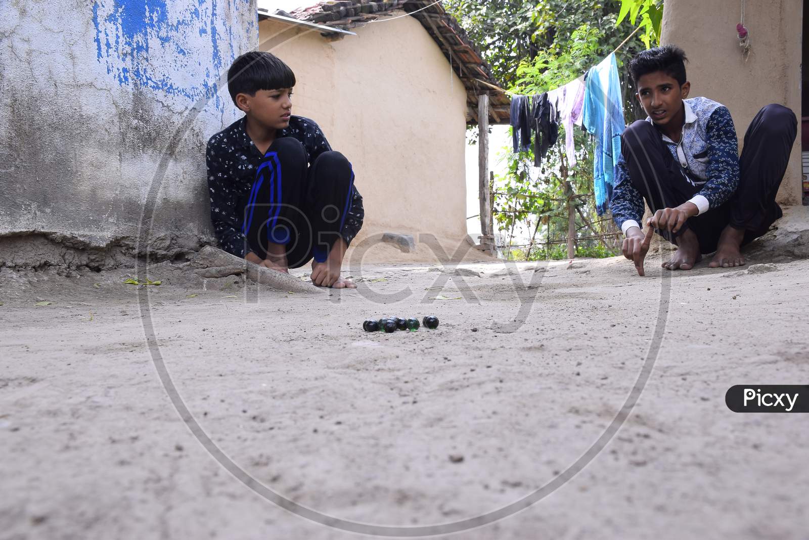 Indian Children Playing Marbles In The Village, Beautiful View Of Rural Sports