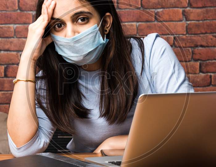 Indian Pretty Girl Working Or Studying Using Laptop Wearing Face Mask