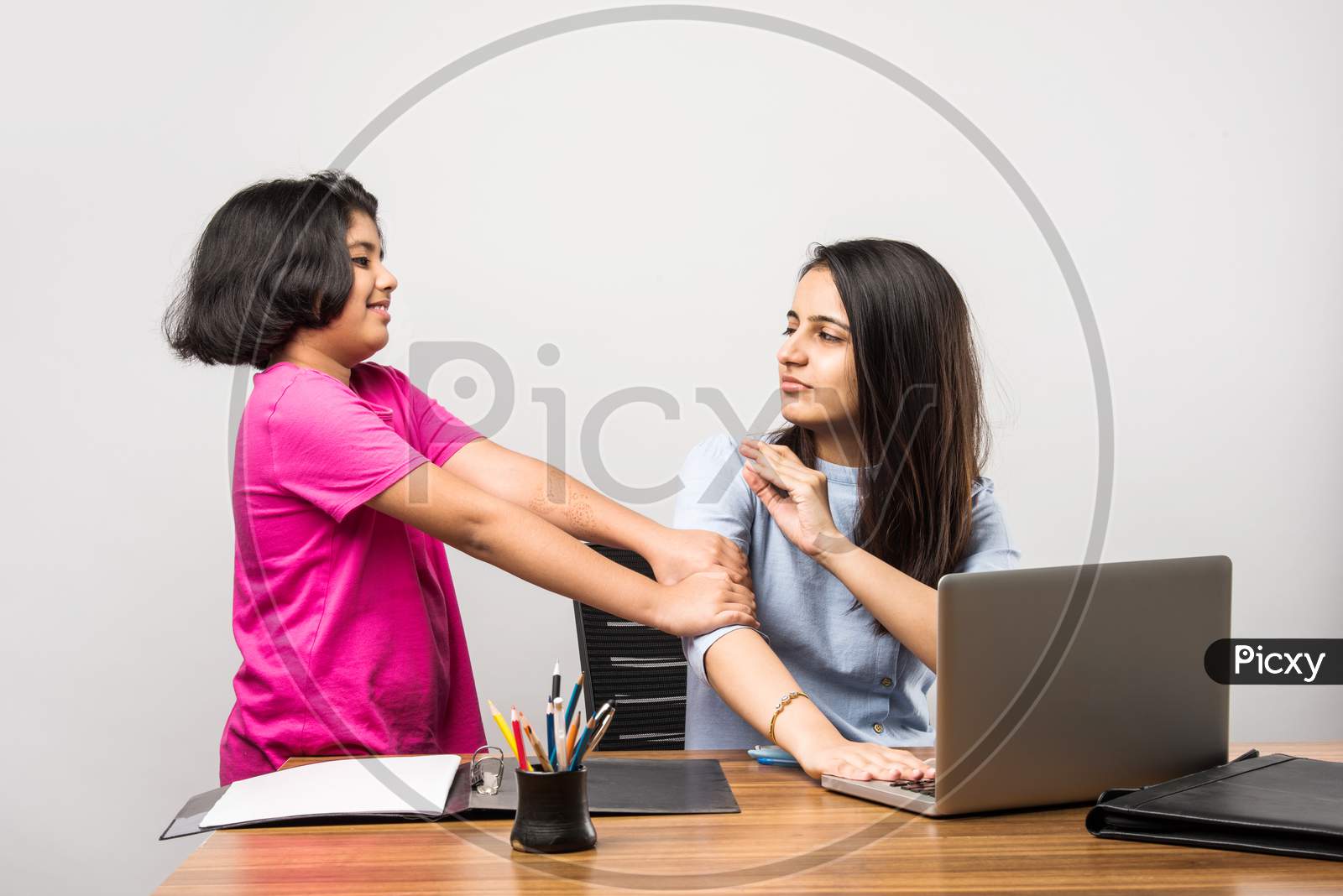 Work From Home Concept - Indian Mother Or Mom Working While Cute Little Daughter Is Around