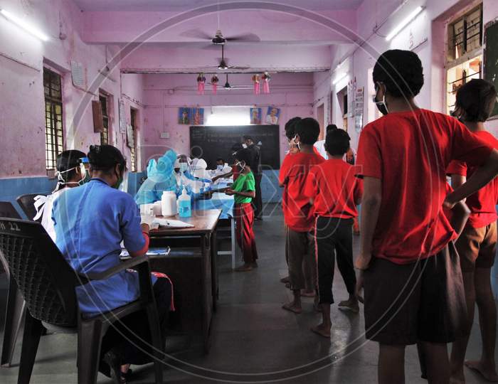 Kids line up to get screened during a check up campaign for the coronavirus disease (COVID-19), at a children's home, in Mumbai, India July 28, 2020.