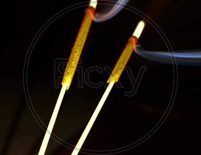 Incense sticks leaving fragrance in form of smoke.