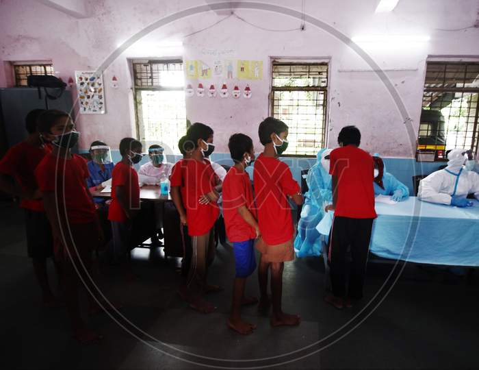 Kids line up to get screened during a check up campaign for the coronavirus disease (COVID-19), at a children's home, in Mumbai, India July 28, 2020.
