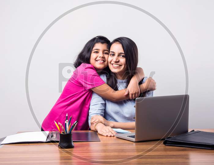 Work From Home Concept - Indian Mother Or Mom Working While Cute Little Daughter Is Around