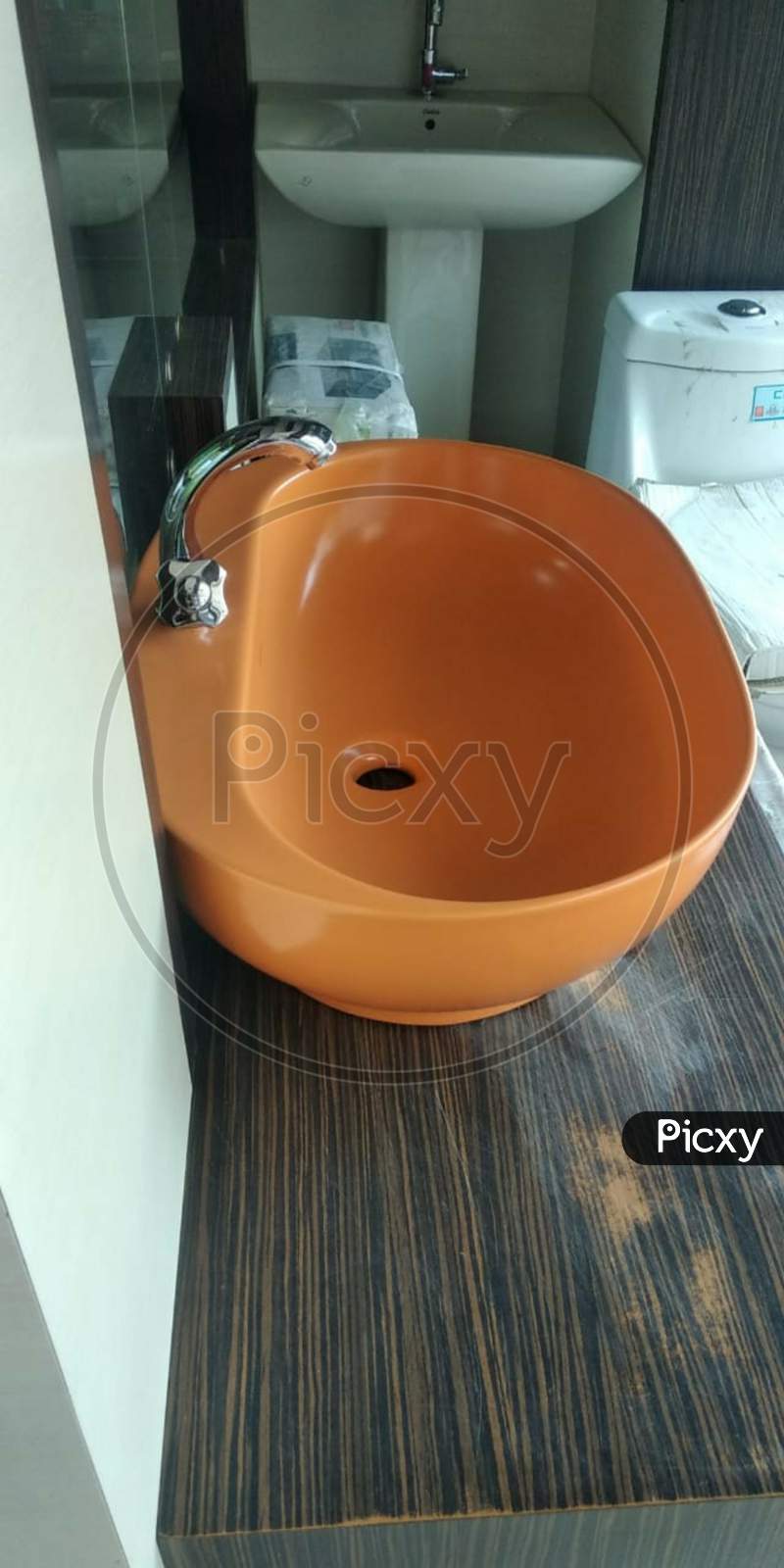 bathroom  orange washbasin with the tap